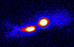 Infrared image of the collision of the active galaxy TXS 2116�077 (right) and a companion galaxy (left), with X-ray contours