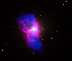 Chandra X-ray, radio and optical image of M84 showing X-ray cavities evacuated by the radio jet from the supermassive black hole