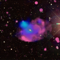 the Cloverleaf Odd rRdio Circle in visible light (Dark Energy Spectroscopic Instrument Legacy Survey), in white and yellow; X-rays from XMM-Newton in blue;  radio from the Australian Square Kilometer Array Pathfinder in red.